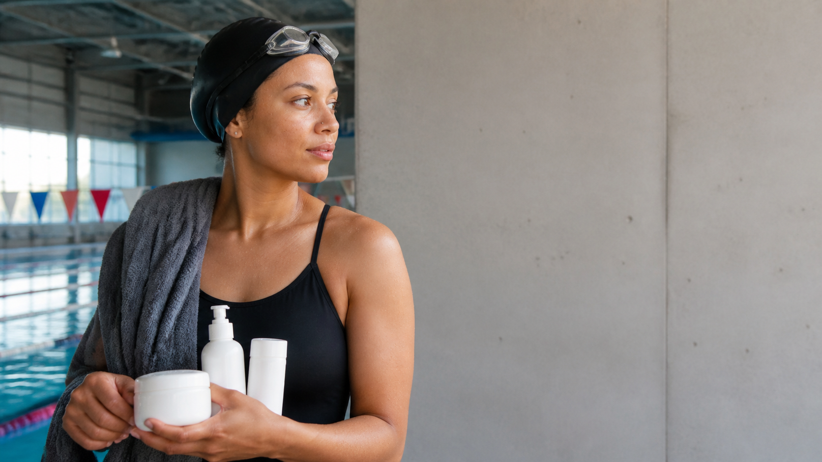 A swimmer rinses promptly with a cap, towel, and simple blank care products nearby